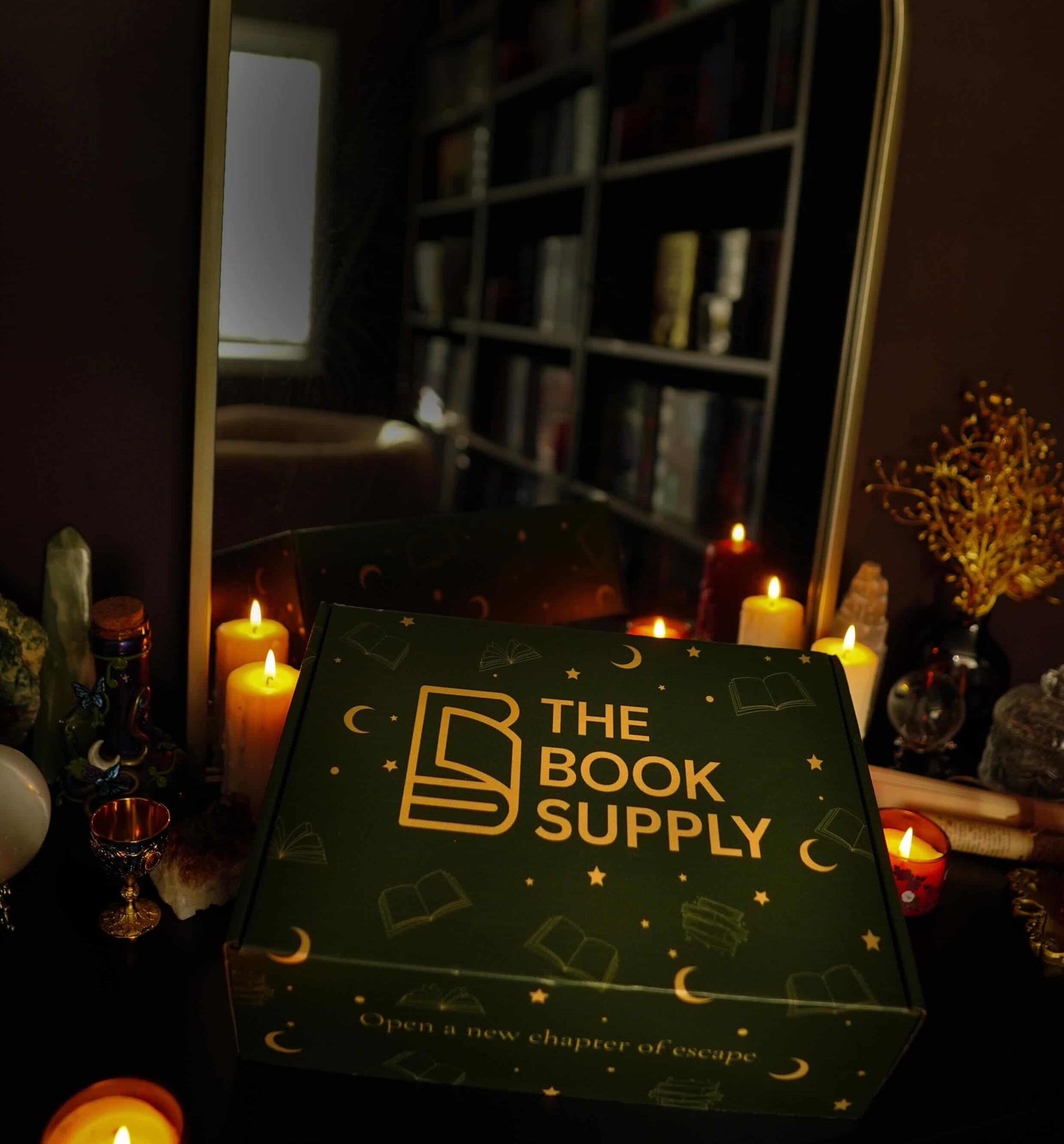The Book Supply box with candles and a mirror in the background