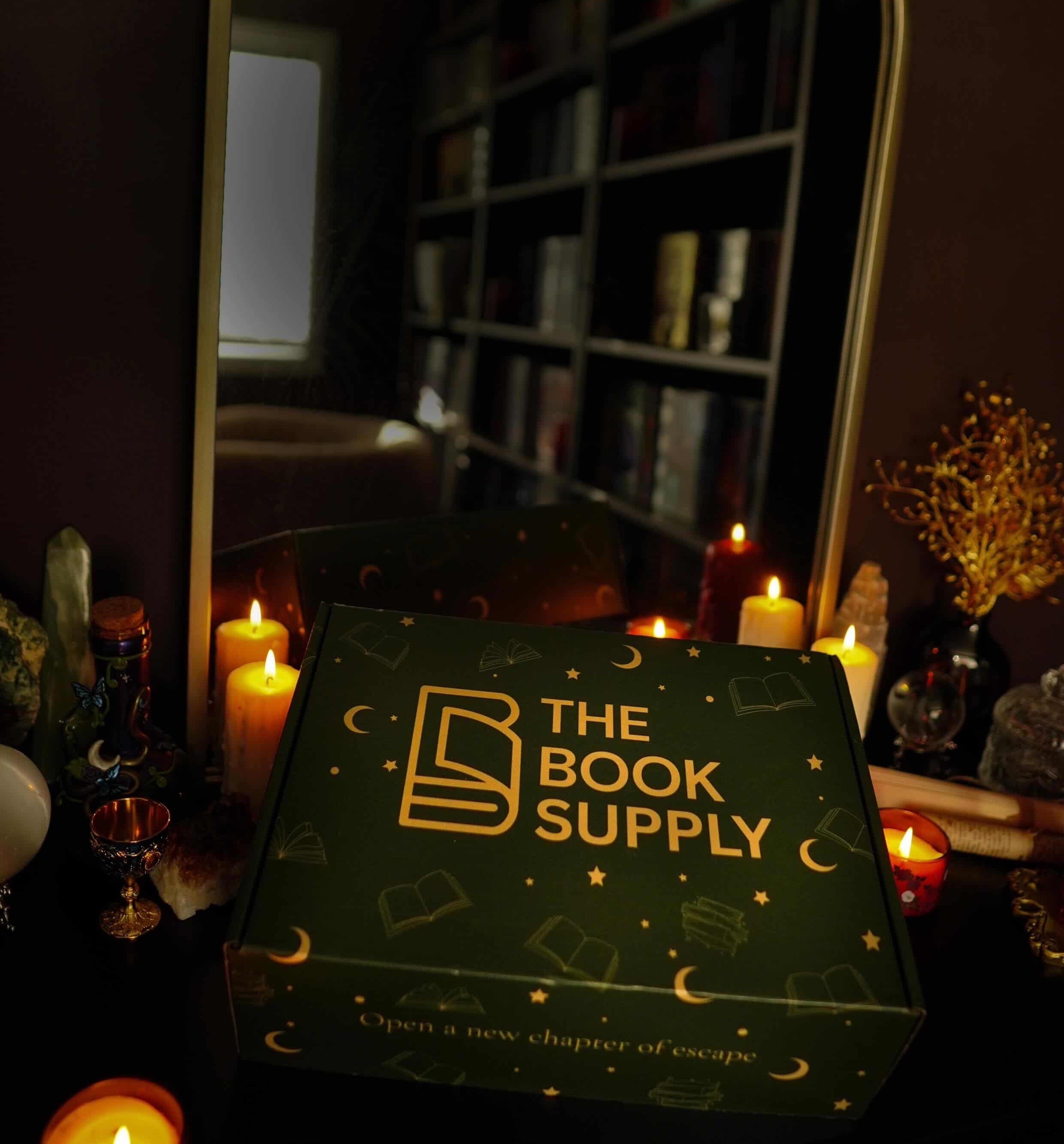 The Book Supply box with candles and a mirror in the background